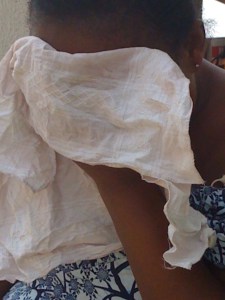 Doris, the grandmother of a 13-year-old rape victim, cries into her handkerchief as she recounts the story.