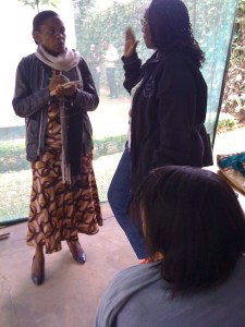 MJ93fm reporters Rotlinde and Bilhuda interview PWC's Maanda Ngoitiko, while two immigration officers wait for me to exit.