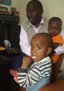 Pippi House founder Aristides Nshange with two little girls.