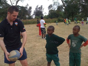 Yes! Tanzania trustee Lewis Patience helps Kittyler teach  ARDP kids.