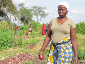25-year-old Tanzanian onion farmer Juliana Amadeus pauses from her work in Kirya village, a semi-arid region of northern Tanzania.