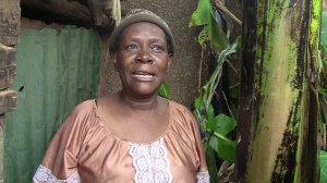 Ruth Nalunkuma outside of chicken coop