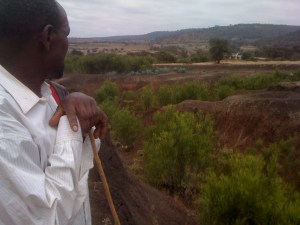 Mixed farmer, Jeremiah Chuma looking out over the Korongo or canyon that cuts across his land like a knife wound. 