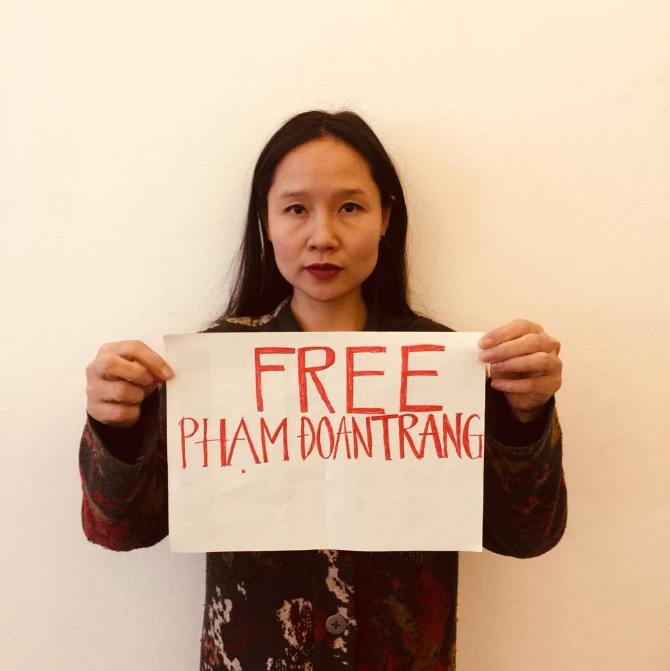 Pham Doan Trang was arrested last March for her book Politics for the Masses - Free Pham Doan Trang sign held by Vietnamese musician Mai Khoi courtesy of Do Nguyen Mai Khoi Facebook page
